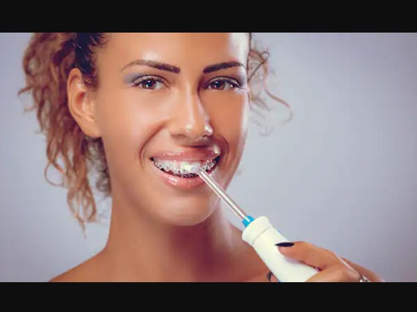 What are the reasons for using the four bleeding gums of an oral irrigator?